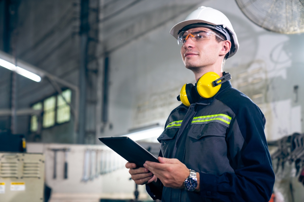 a warehouse professional using a tablet to manage field service issues